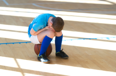 Crying boy basketball