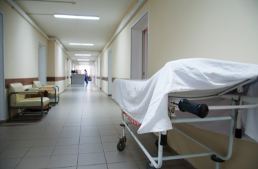 Empty hospital hallway with bed