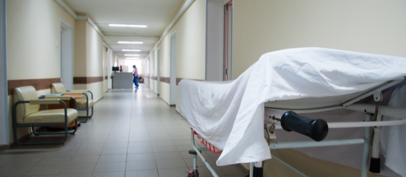 Empty hospital hallway with bed