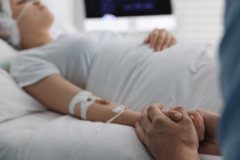 Image of patient in a coma with loved one.