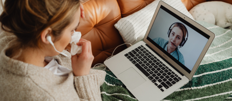 Woman on laptop during telehealth appointment with doctor