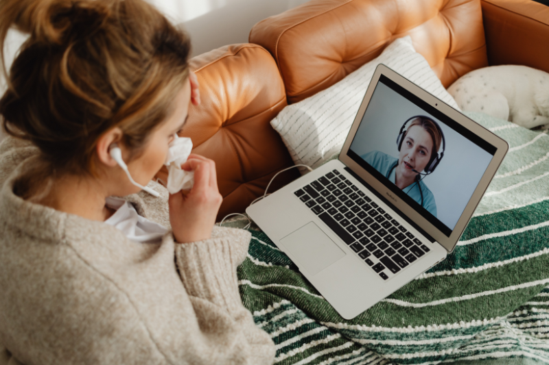 Woman on laptop during telehealth appointment with doctor