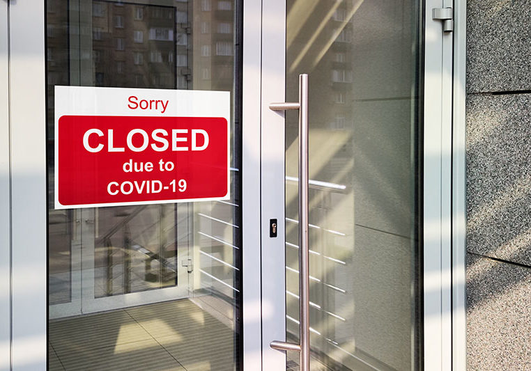 Business center closed due to COVID-19, sign with sorry in door window. Stores, restaurants, offices, other public places temporarily closed during coronavirus pandemic. Economy hit by corona virus.