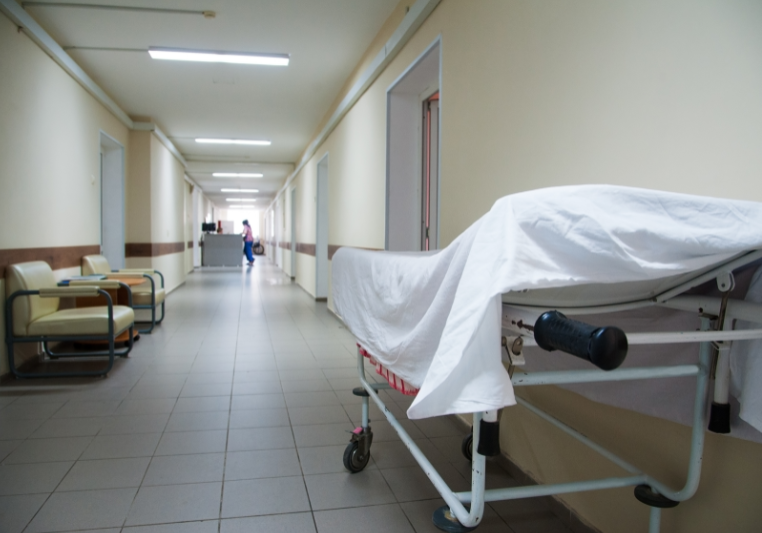 Empty hospital hallway with bed