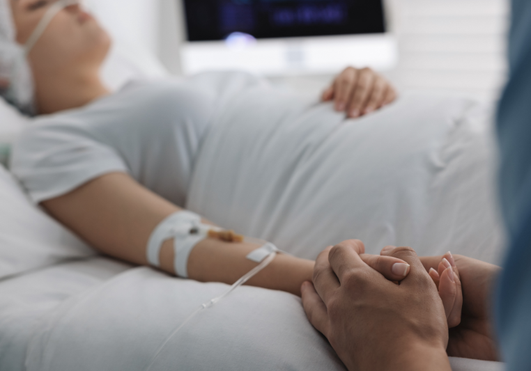 Image of patient in a coma with loved one.
